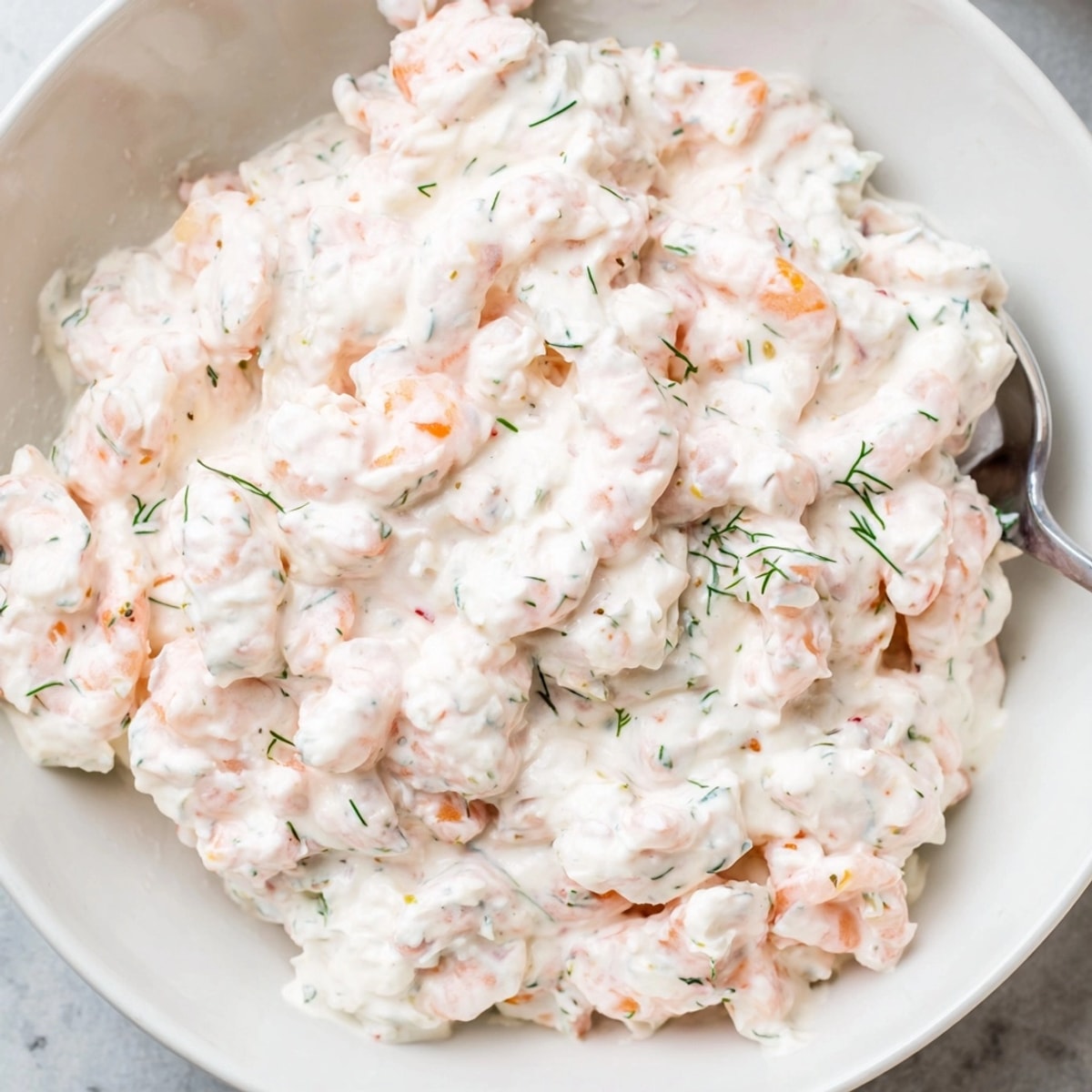 Close-up of homemade Shrimp Dill Yogurt Dip being served with crisp slices of cucumber.