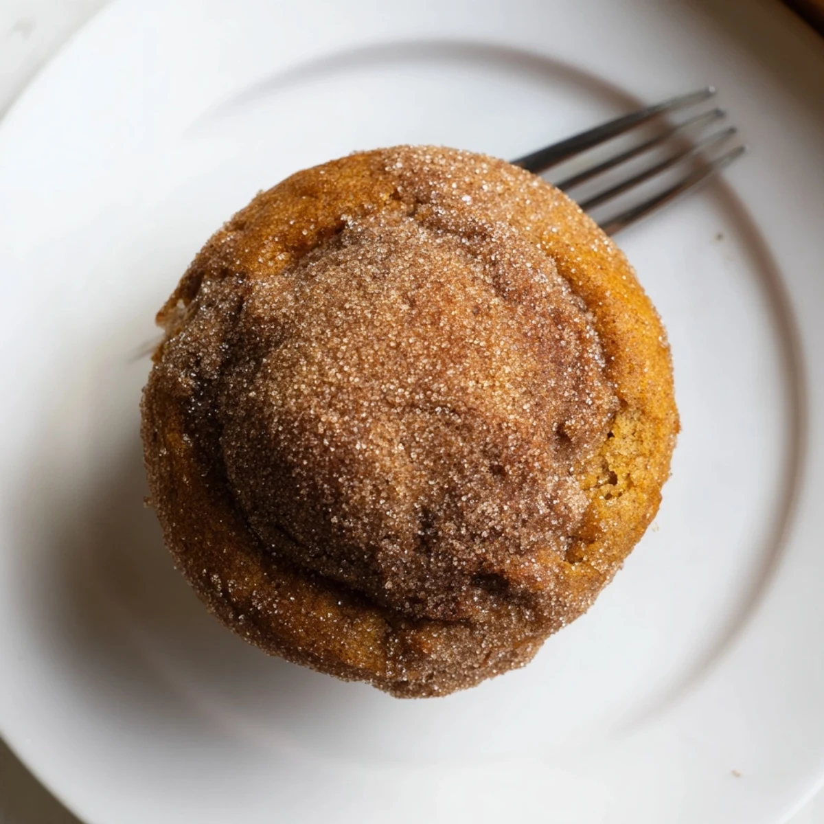 Warmly spiced gingerbread pumpkin muffin donuts topped with cinnamon sugar, perfect for fall.