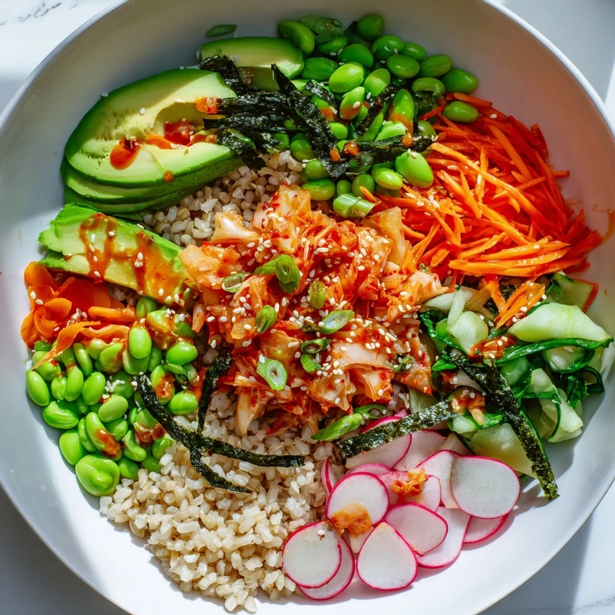 Savory fermented vegetable bowl topped with avocado, radishes, and sesame seeds.