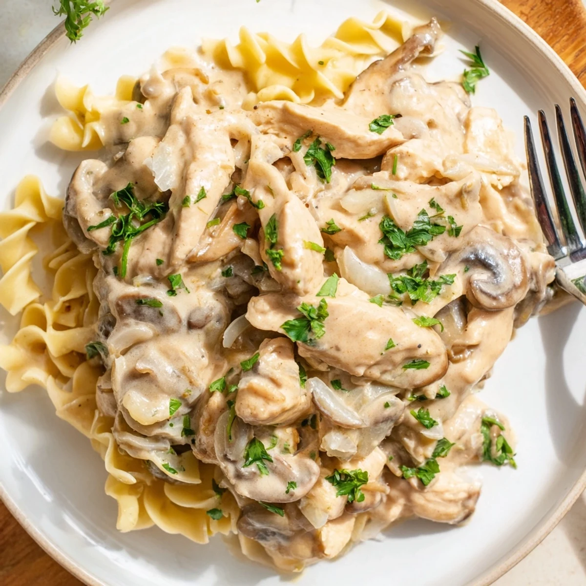 Rich and savory Creamy Chicken Stroganoff with tender chicken and mushrooms in sauce.  