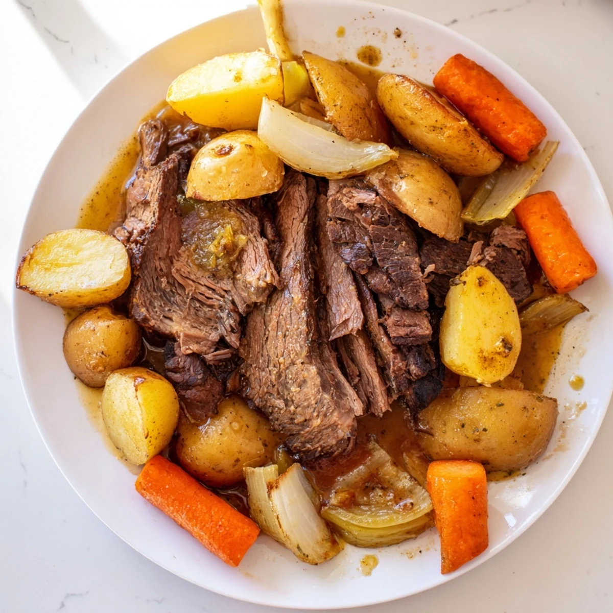 Fork-tender Sunday Pot Roast with a rich gravy, serving suggestion of colorful roasted veggie medley.
