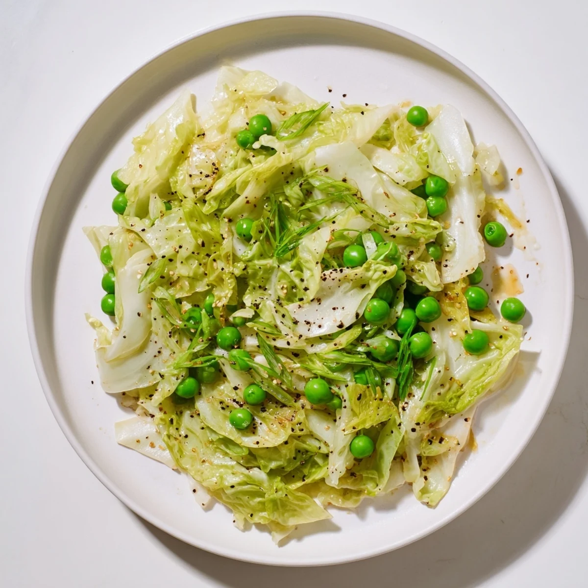 This savory cabbage stir-fry features vibrant green peas and a delicious garlic-soy glaze.