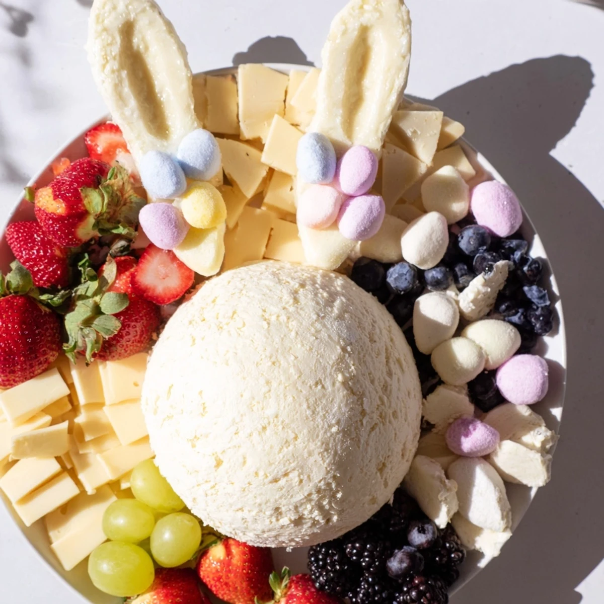 This Bunny Ears Easter Board features a goat cheese bunny nose surrounded by colorful fruits and crackers.