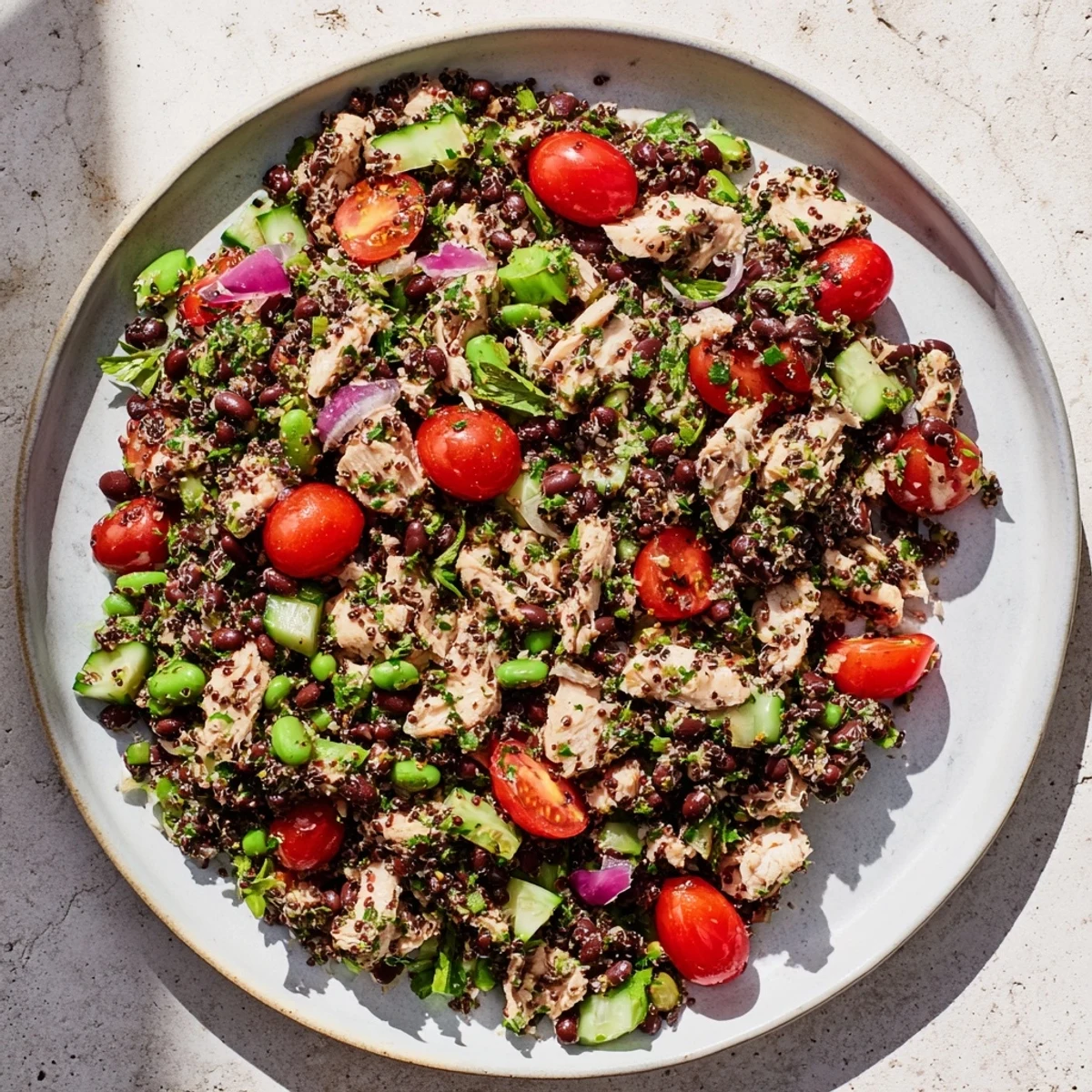 Dense Bean Salad with Lemon-Dill Chicken, featuring colorful vegetables and tender chicken, is ready to eat.