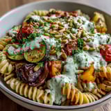 Roasted zucchini and bell peppers tossed into a Whole Wheat Pasta Bowl with rich, creamy sauce.