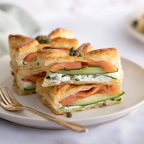 Golden Étoiles Filantes Assiette de Fin dAnnée: puff pastry stars topped with smoked salmon, ready to eat.