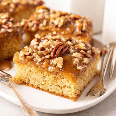 Deliciously moist caramel pecan cookie sheet cake drizzled with warm glaze.  