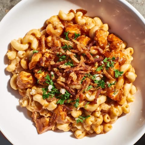 A piping hot dish of One-Pot Honey BBQ Chicken Mac and Cheese, cheesy and delicious.