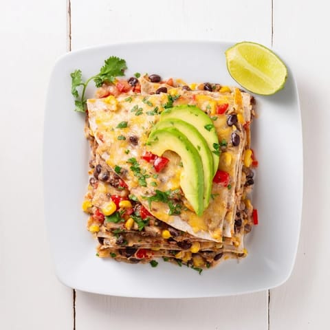 A close-up view of the hearty Quick Black Bean and Corn Tortilla Casserole, garnished with fresh cilantro and avocado.