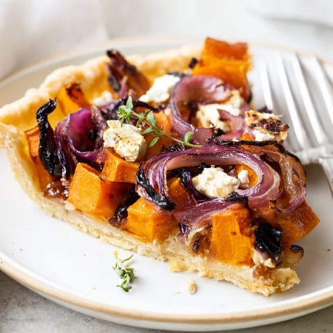 Golden-brown Feuilles dÉrable Tartes Salées d'Automne showcasing roasted vegetables and a flaky pastry crust.