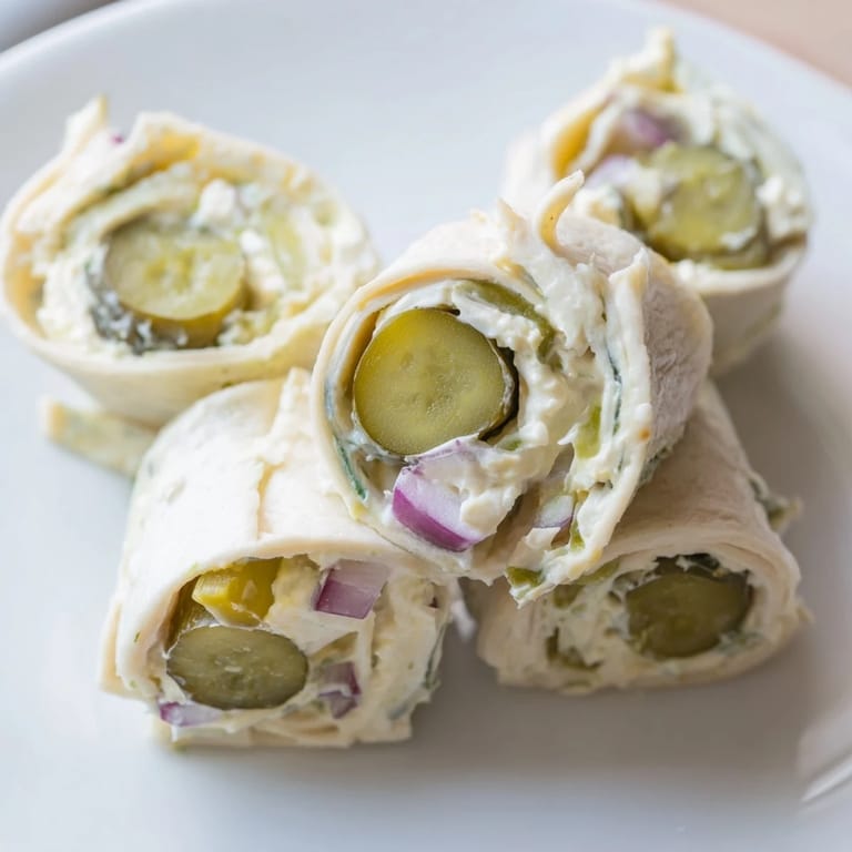 Easy-to-make Pickle-in-a-Blanket featuring creamy cheese and zesty dill pickles.