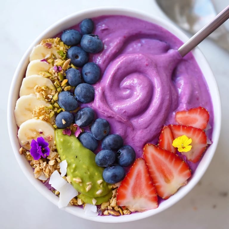 Colorful smoothie bowls topped with fresh fruits and granola for a nutritious start.  