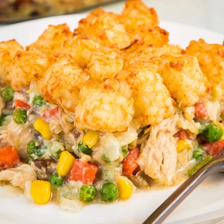 Warm, creamy Tater Tot Chicken Pot Pie filling under a blanket of perfectly browned, crunchy tots.