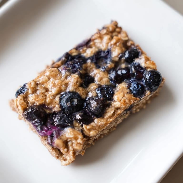 Close-up of freshly baked Blueberry Banana Oatmeal Protein Bars, a healthy and tasty snack option.